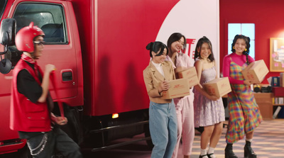 a group of people standing in front of a red truck