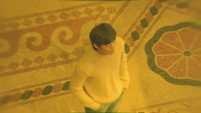 a man standing in front of a tiled floor