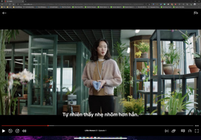 a woman standing in a room with plants