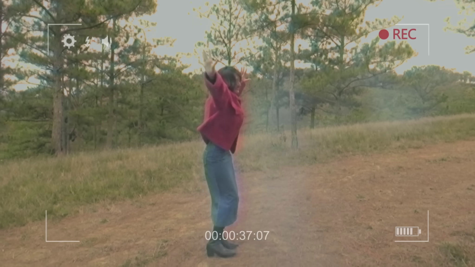 a person standing in the middle of a dirt road