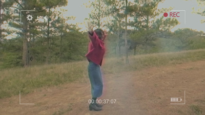 a person standing in the middle of a dirt road