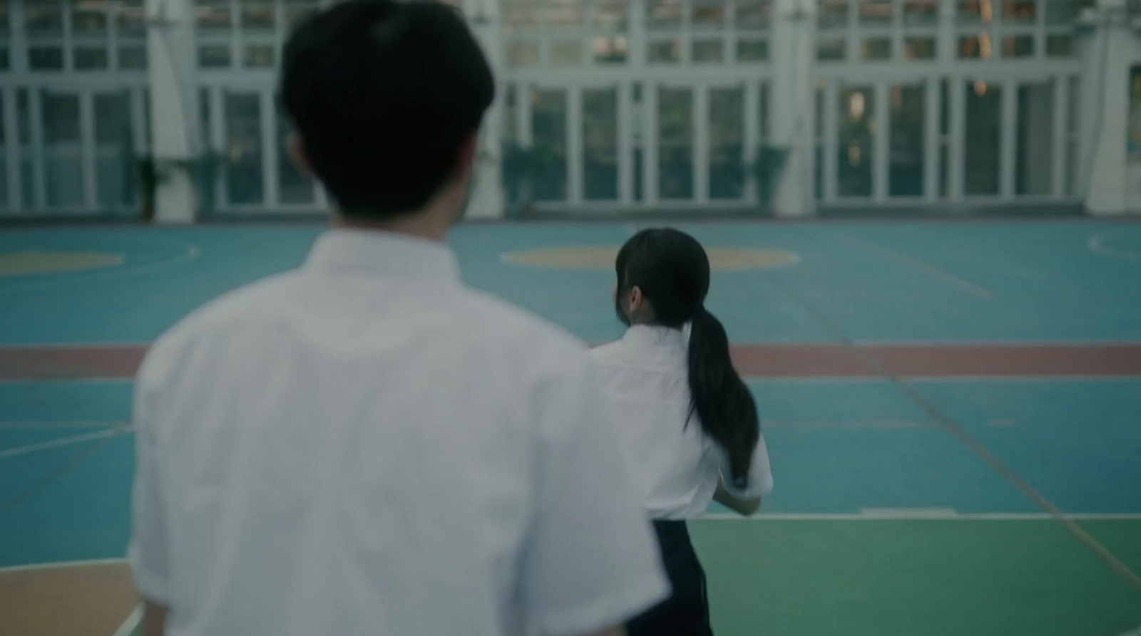 a man and a woman standing on a tennis court