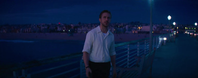 a man standing on a pier at night