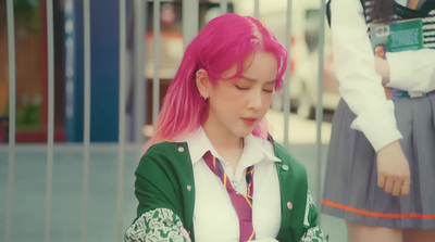 a girl with pink hair and a green and white jacket