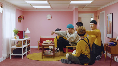 a group of young men sitting around a living room