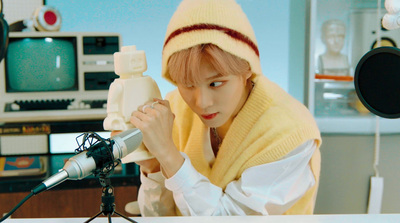 a woman in a yellow scarf holding a microphone