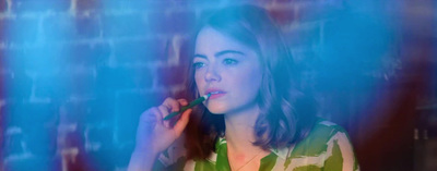 a woman brushing her teeth in front of a mirror