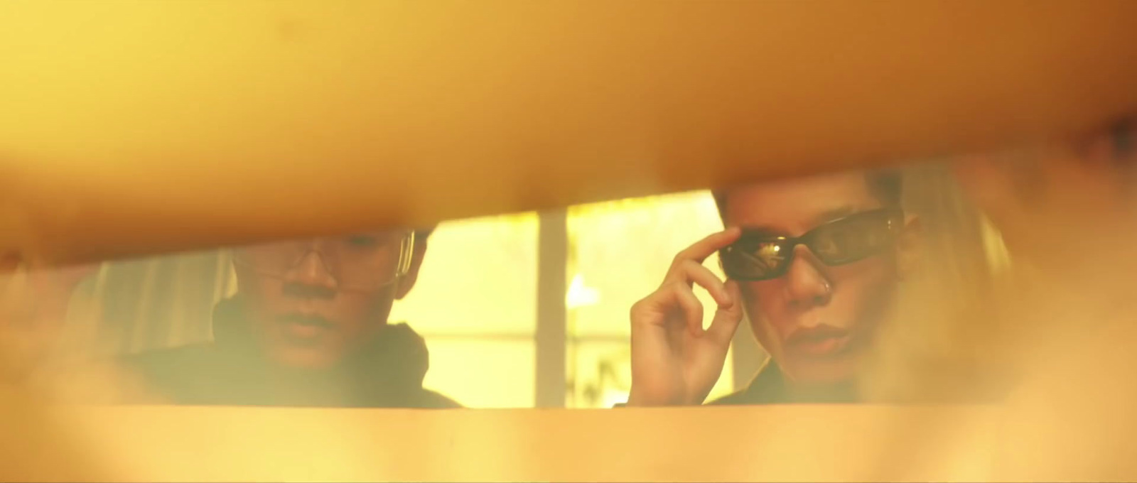 a man and a woman are looking in a mirror