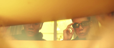 a man and a woman are looking in a mirror