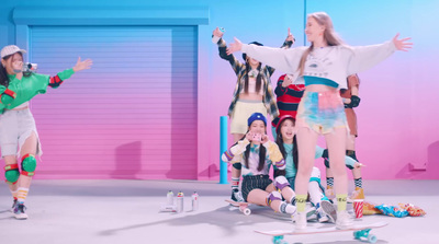 a group of young women riding skateboards on top of a white floor