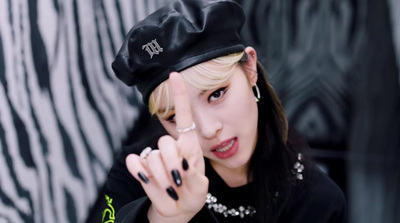 a woman with black nails and a black hat