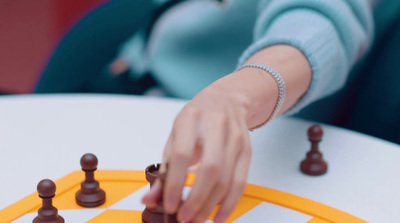 a close up of a person playing a game of chess