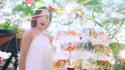 a woman standing in front of a display of drinks