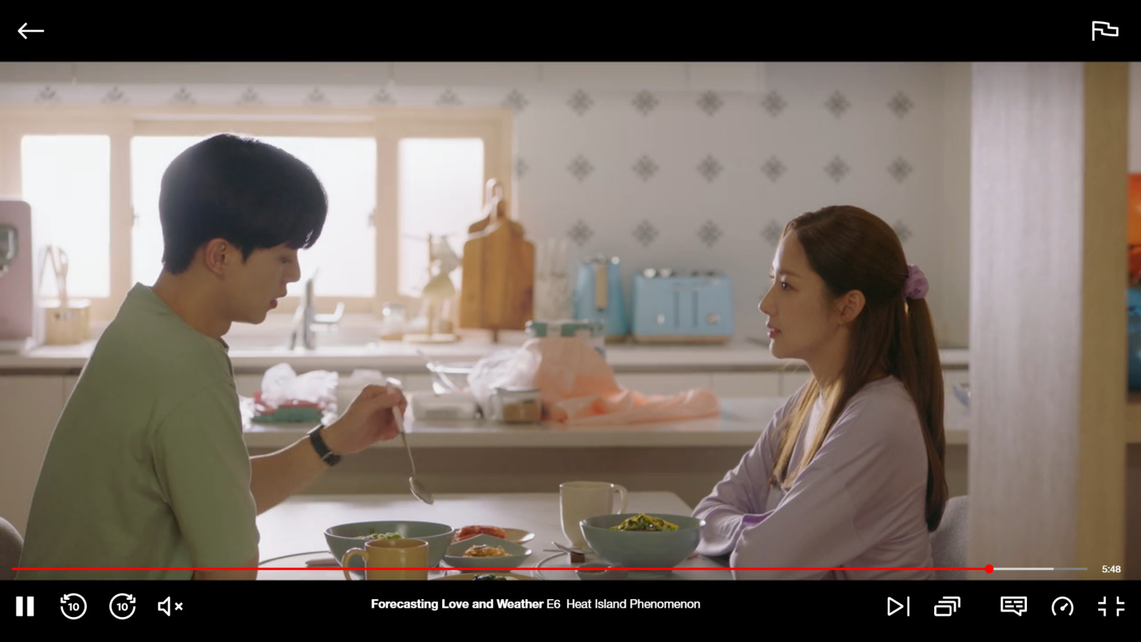 a man standing next to a woman in a kitchen