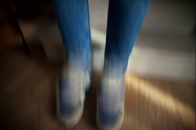 a blurry photo of a person's legs and feet