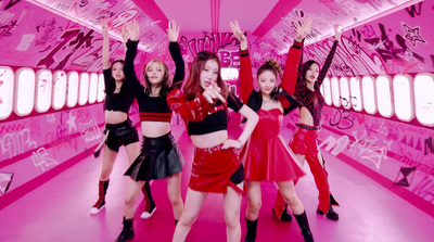 a group of girls dancing in a pink room