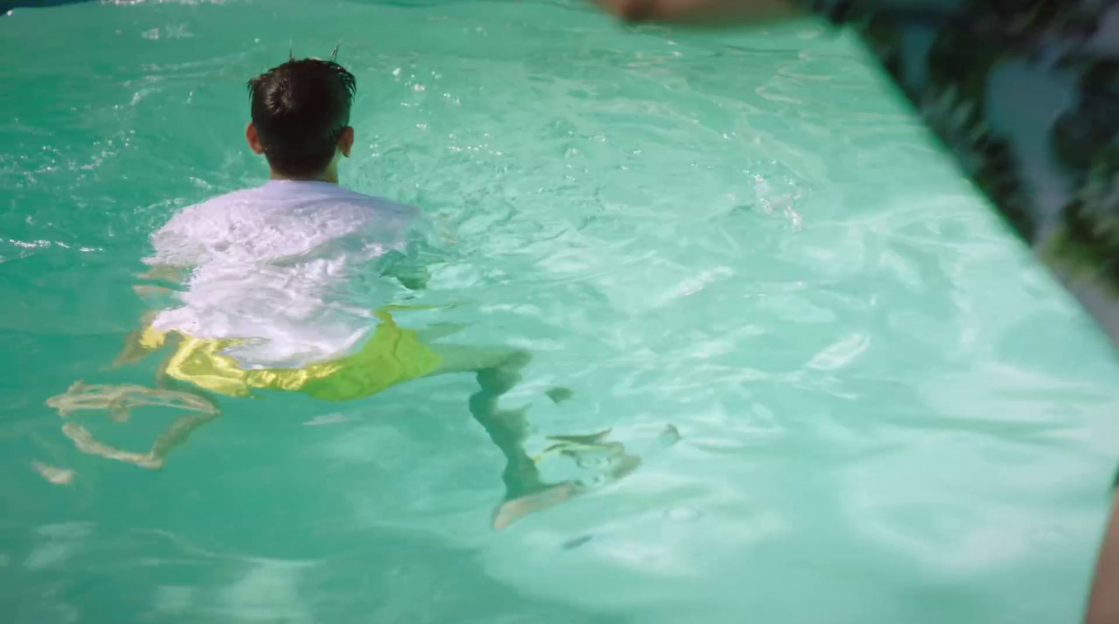 a person in a pool with a frisbee