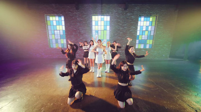 a group of young women standing on top of a stage