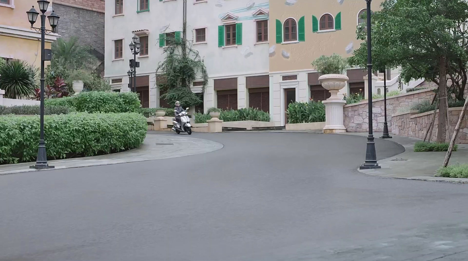 a person riding a motorcycle down a curvy street