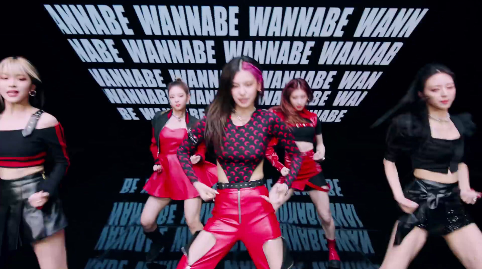 a group of women in red and black outfits