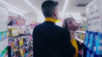 a man and a woman looking at items in a store