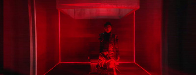 a person standing in a room with red light