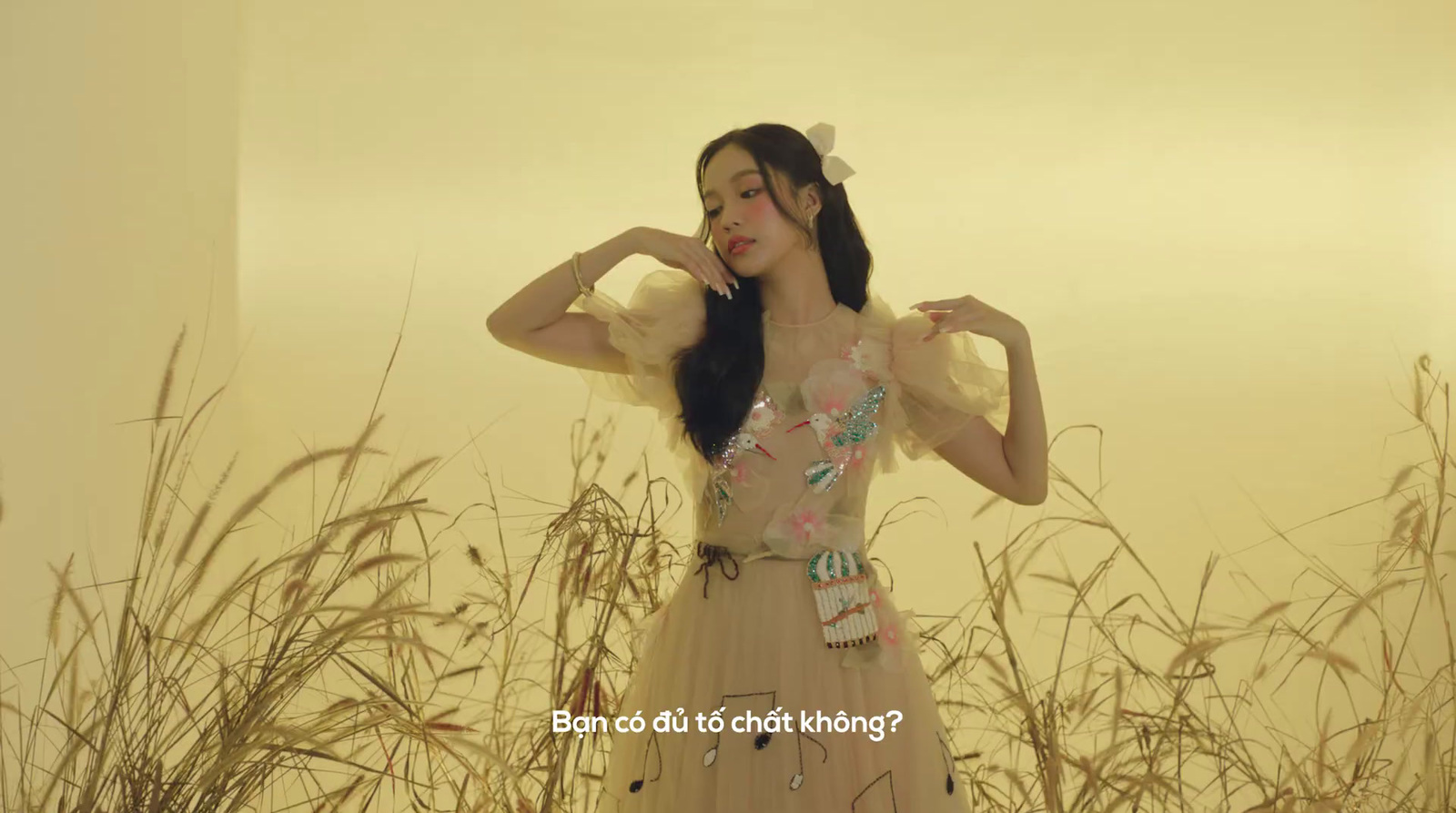 a woman standing in a field of tall grass