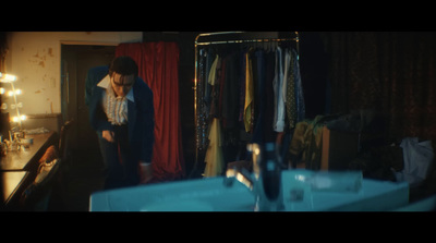 a woman standing in front of a closet filled with clothes