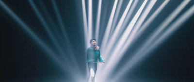 a woman standing in front of a light show