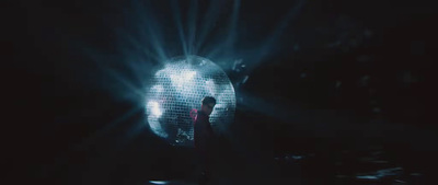 a person standing in front of a disco ball