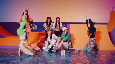 a group of young women sitting on top of a stage