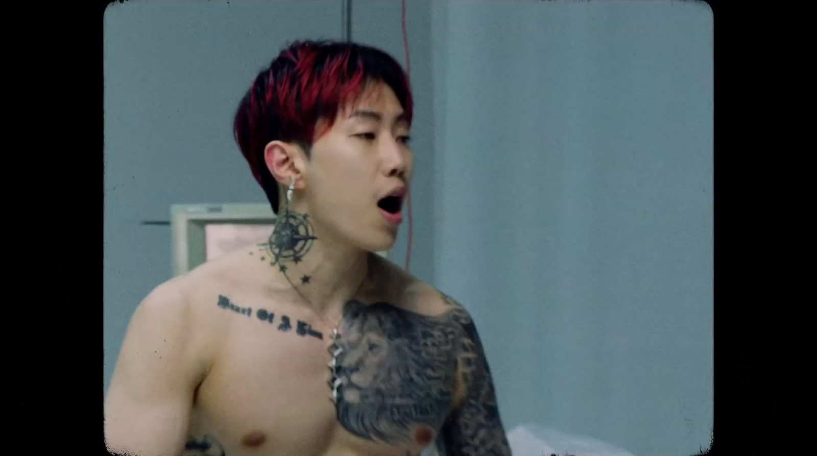 a man with red hair and tattoos on his chest