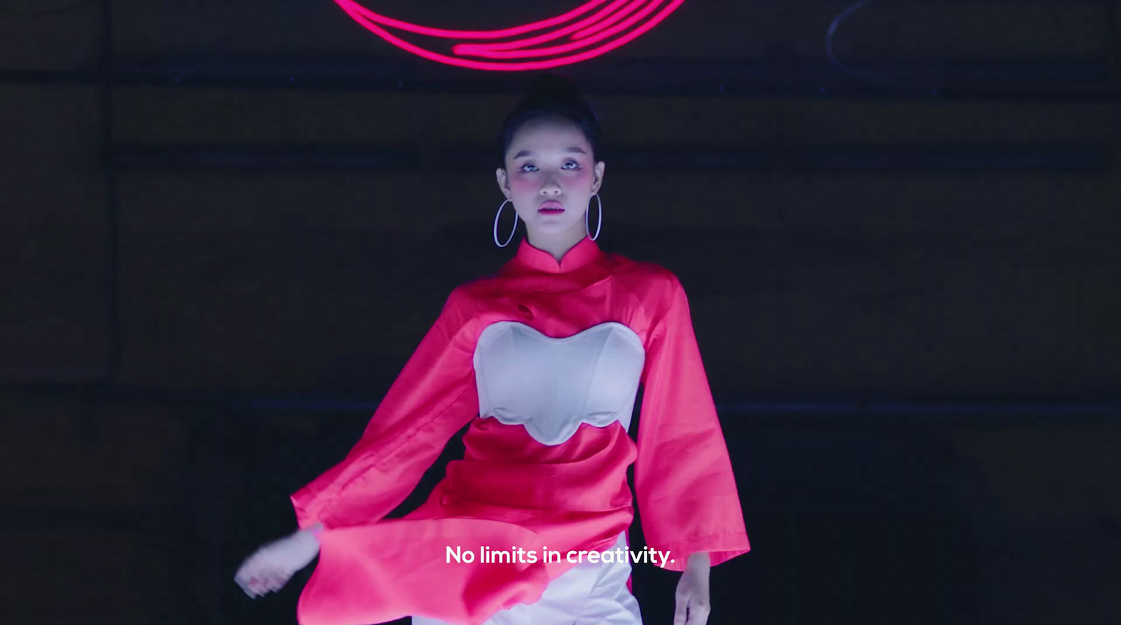 a woman in a red and white outfit walking down a runway