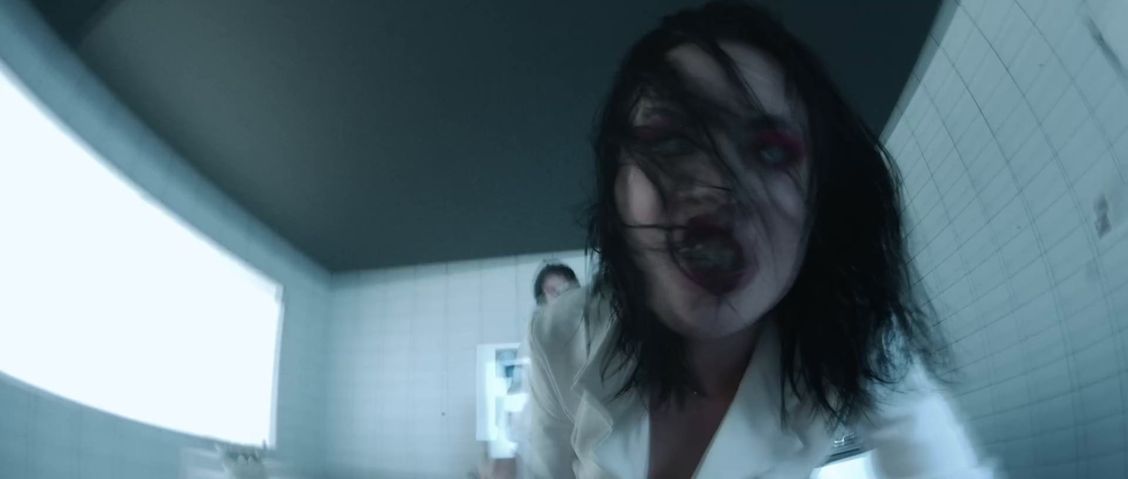 a woman with blood on her face standing in a bathroom