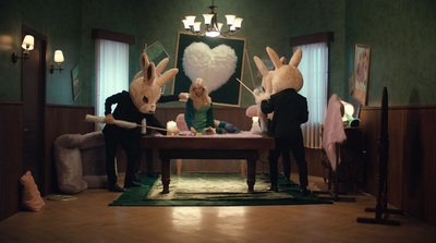 a group of people in bunny ears standing around a table