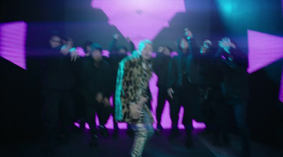 a woman is dancing in front of a group of people