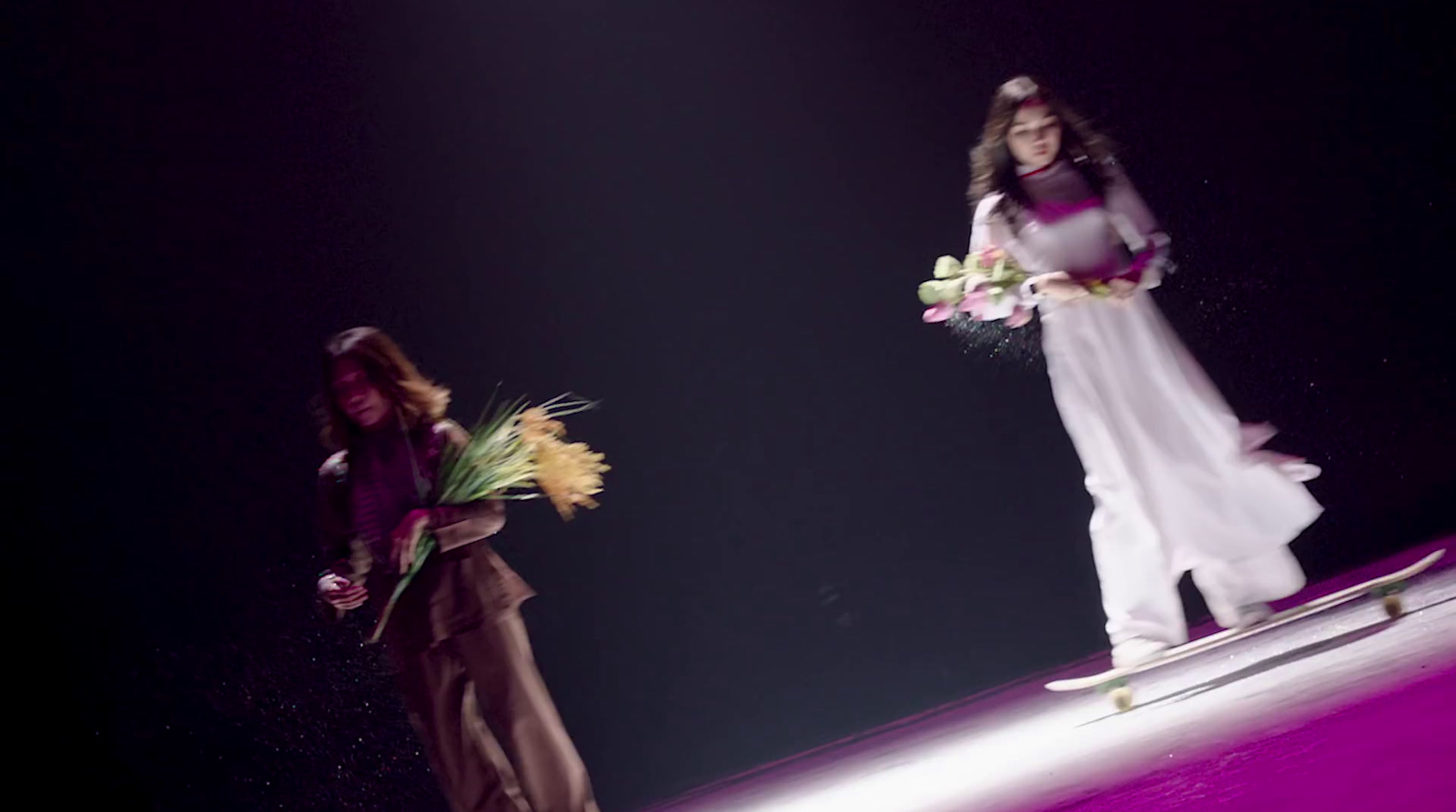 a couple of women standing on top of a snow covered slope