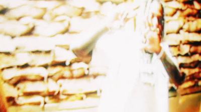 a man standing in front of a display of pastries