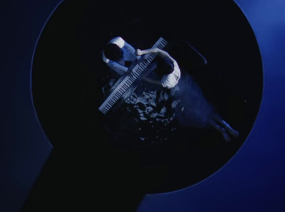 a man is playing a guitar in a dark room