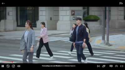 a group of people walking across a street