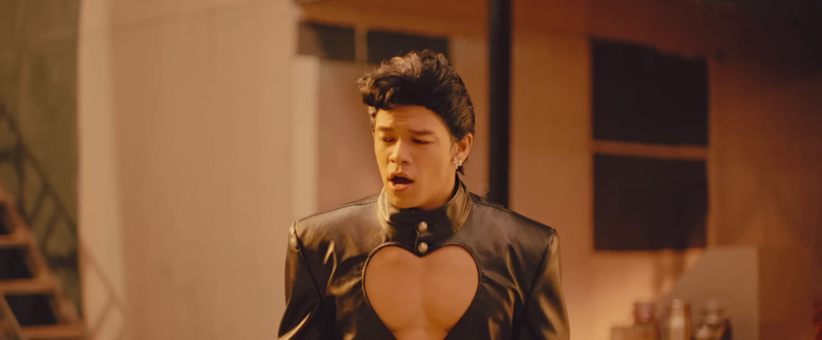 a man in a leather jacket with a heart cut out on his chest