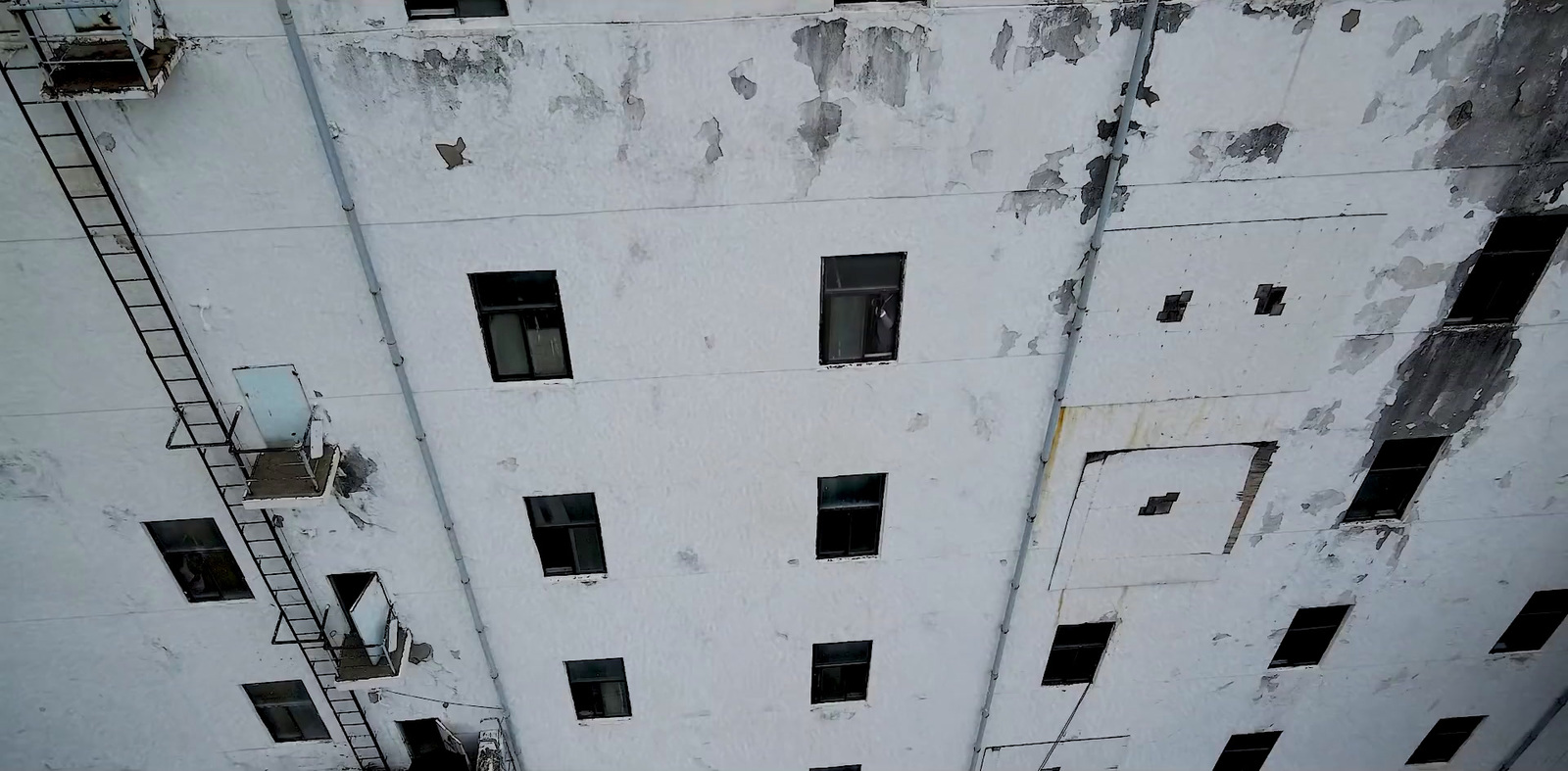 a fire hydrant in front of a white building