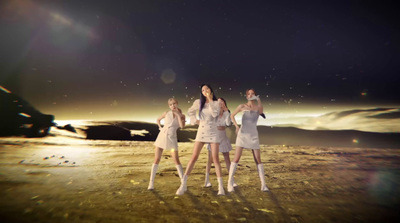 a group of women standing on top of a sandy beach