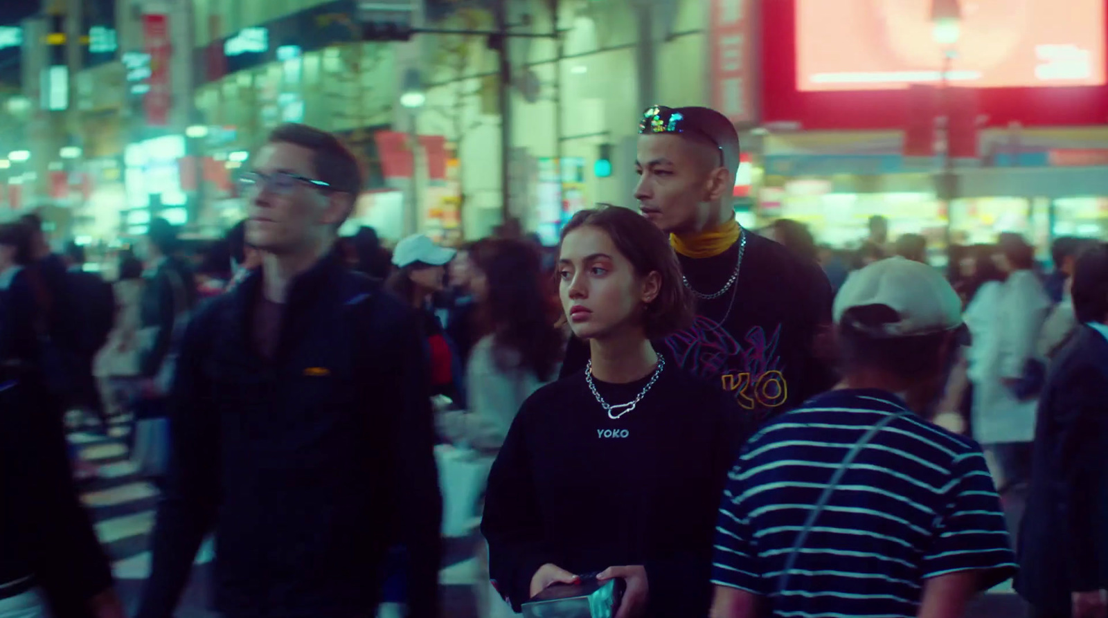 a group of people walking down a busy street