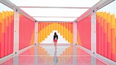 a woman is standing in a colorful room