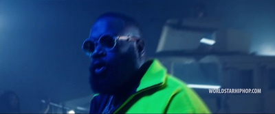 a man wearing a neon green jacket and sunglasses