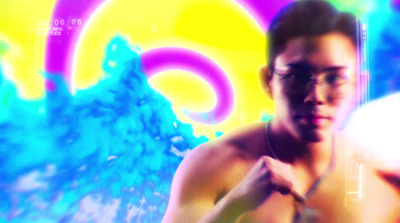 a man with no shirt standing in front of a colorful background