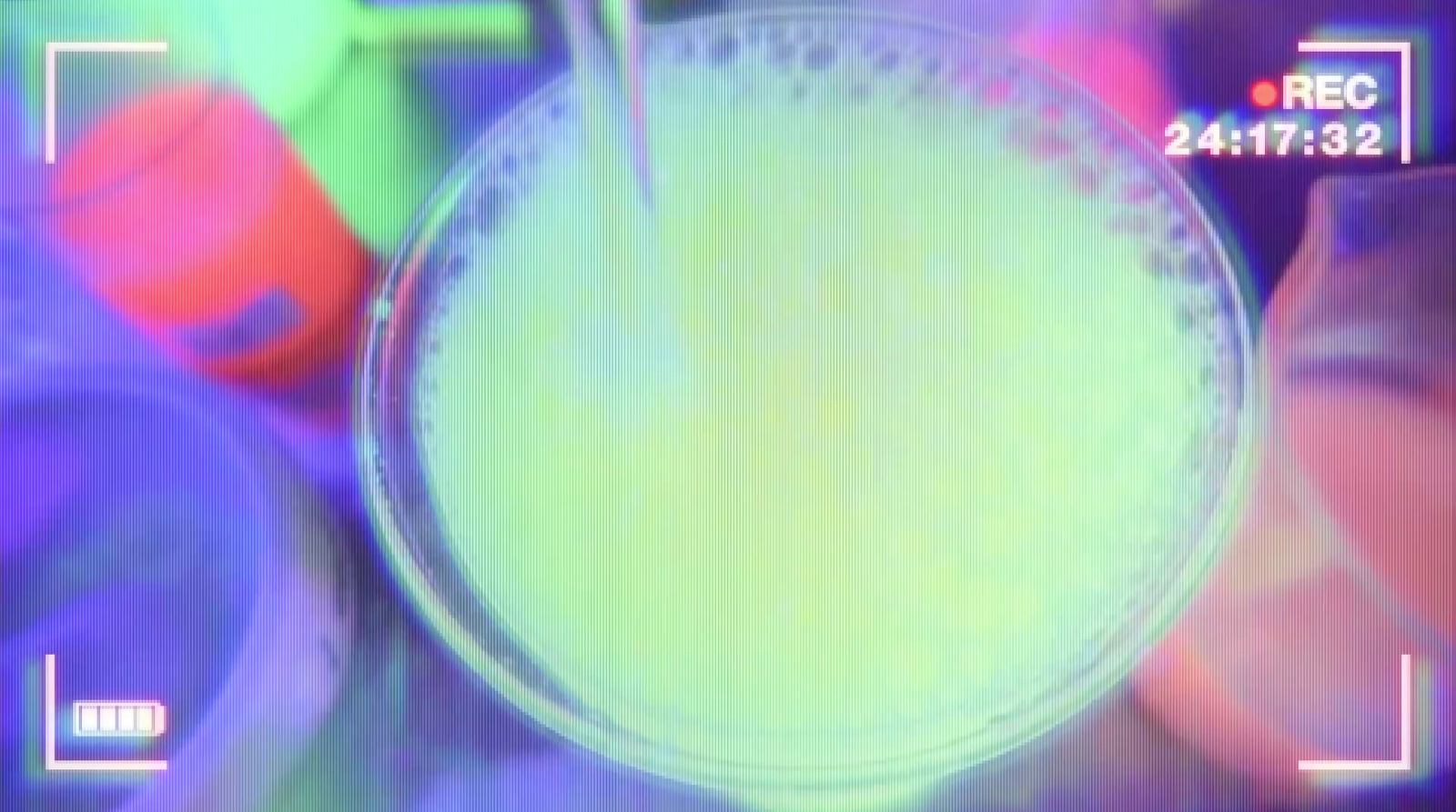 a glass filled with liquid sitting on top of a table