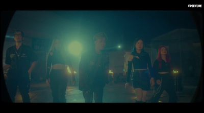 a group of people walking down a street at night