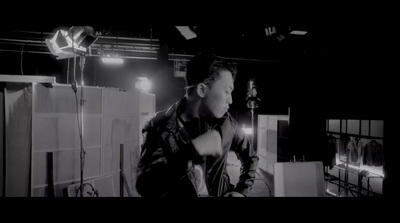 a man standing in front of a camera in a dark room